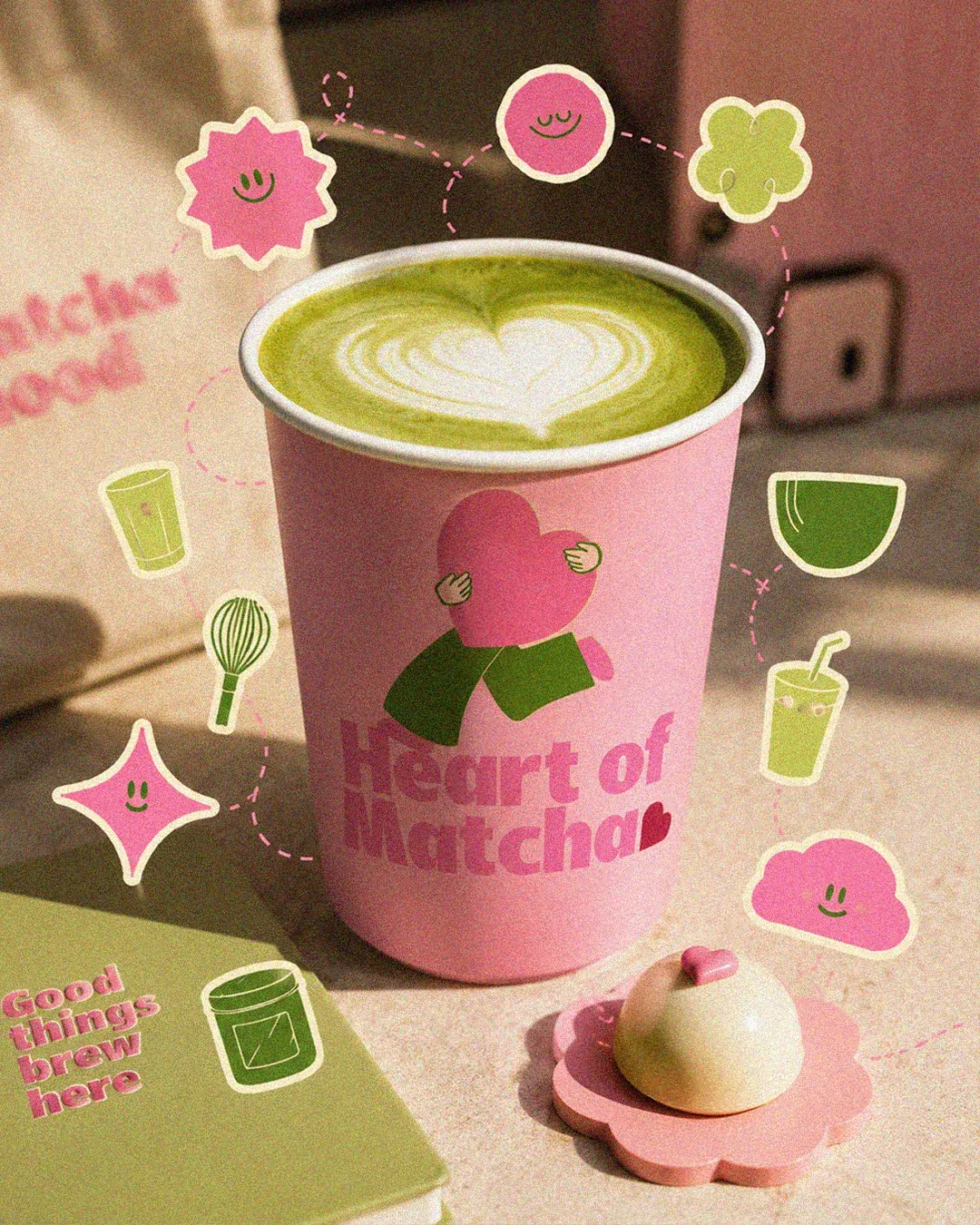 Pink Heart of Matcha paper cup with a heart in the latte foam and sticker doodles. Cafe cup design by LIRCLE