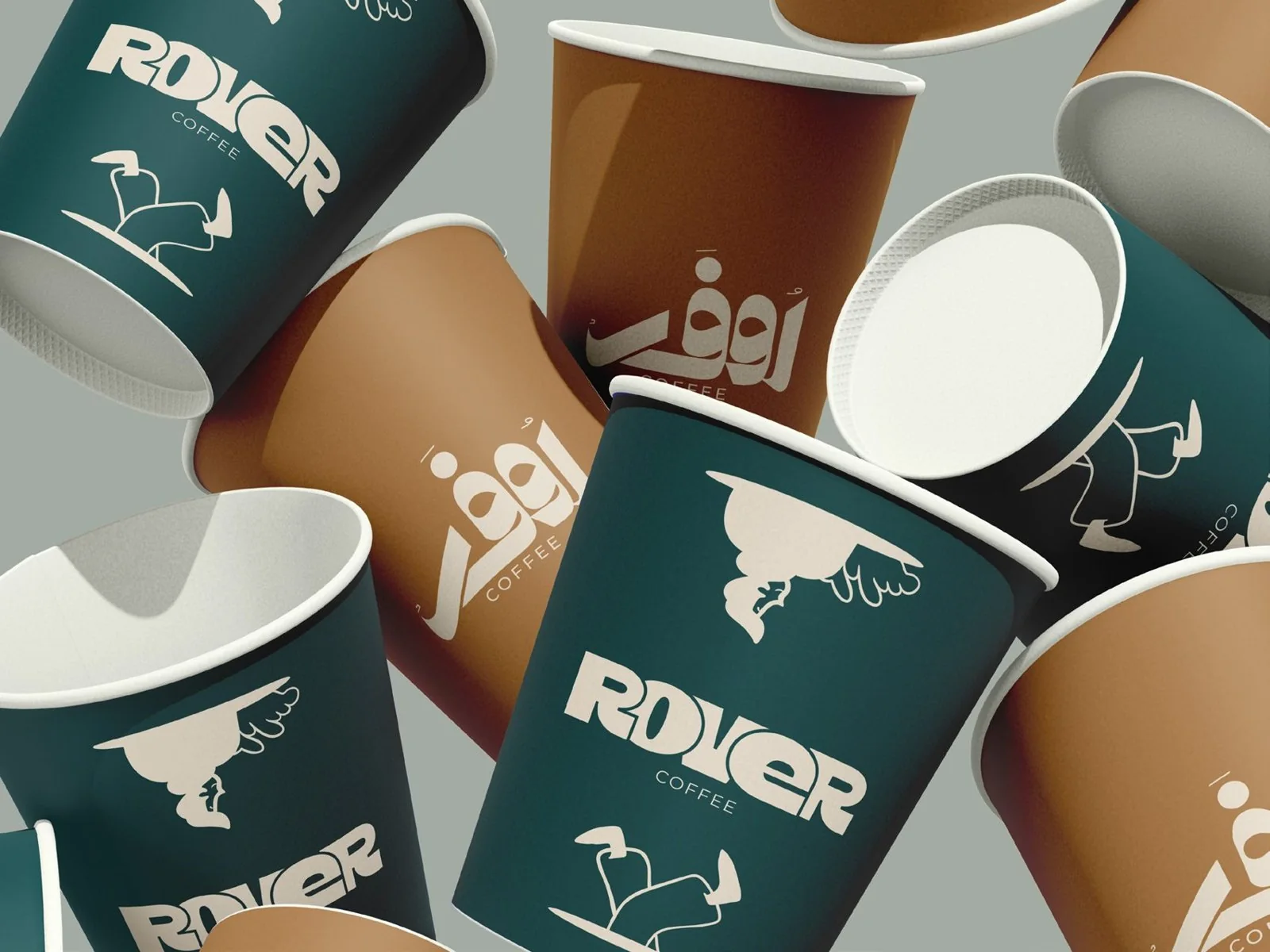 Rover Coffee takeaway cups in teal and brown carrying the English and Arabic wordmarks and the walking-legs drawing. Bilingual coffee brand identity by LIRCLE